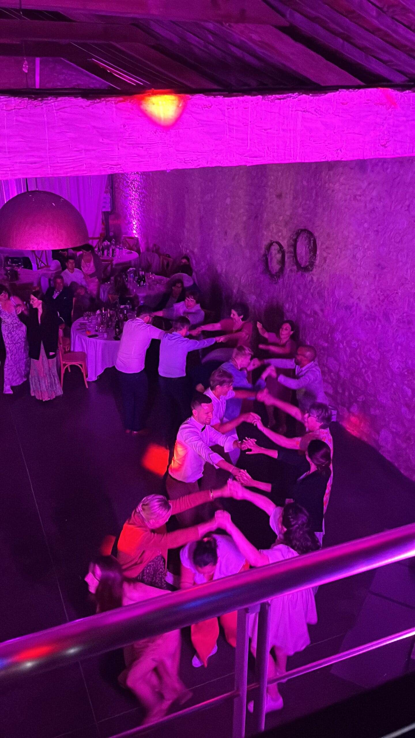 Invités dansant sous les lumières violettes