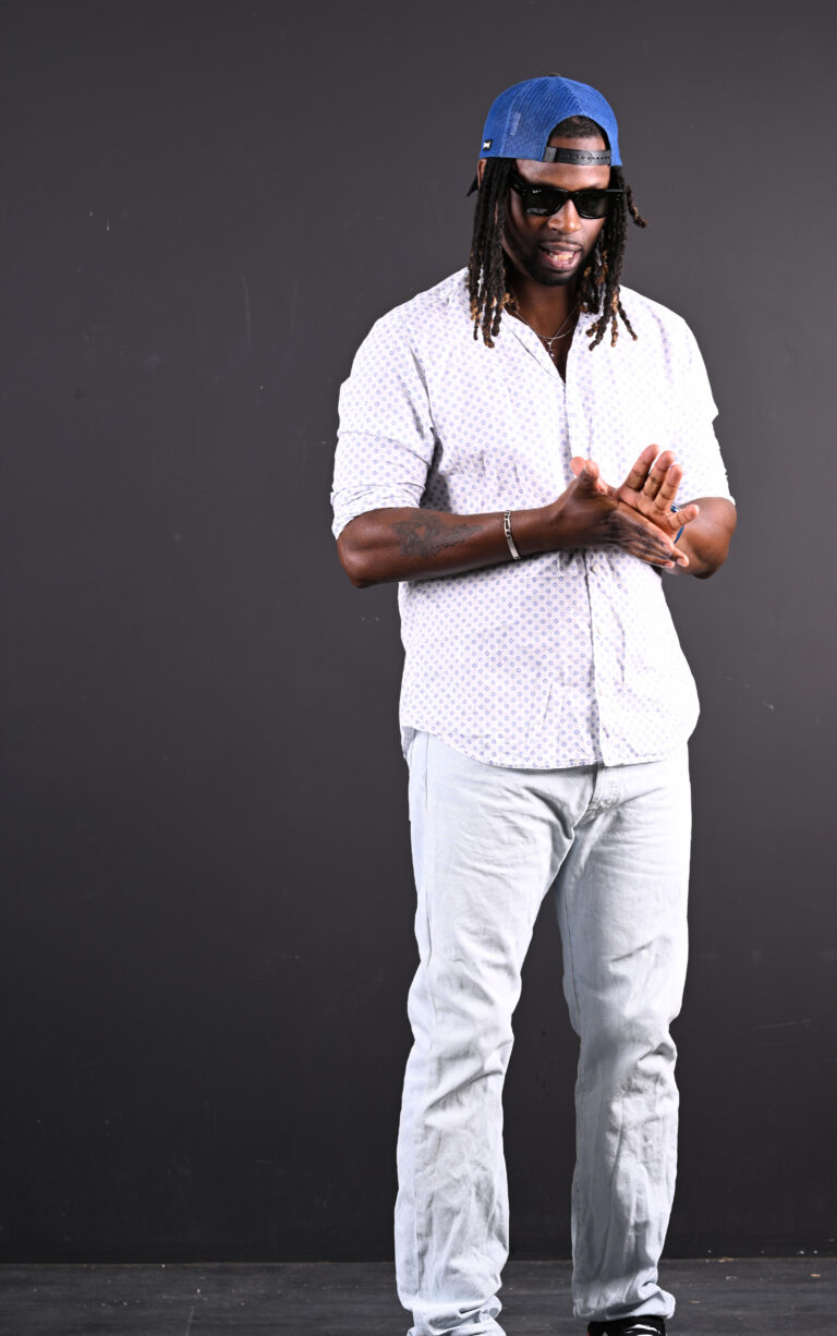 DJ Lexvolution en tenue blanche lors d’un portrait artistique